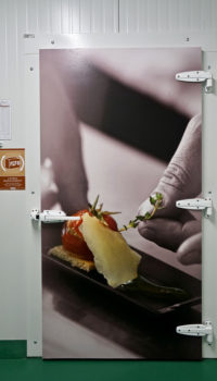 newrest photo of someone adding a garnish to food